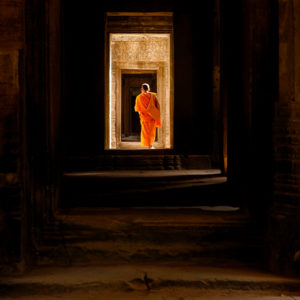 Monk walking through Angkor Wat