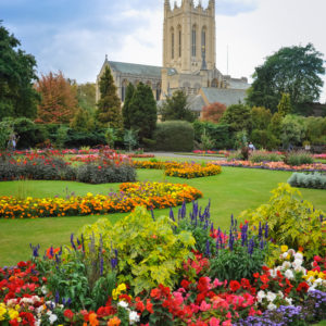 Busy St Edmunds Cathedral with a beautiful flower garden, England