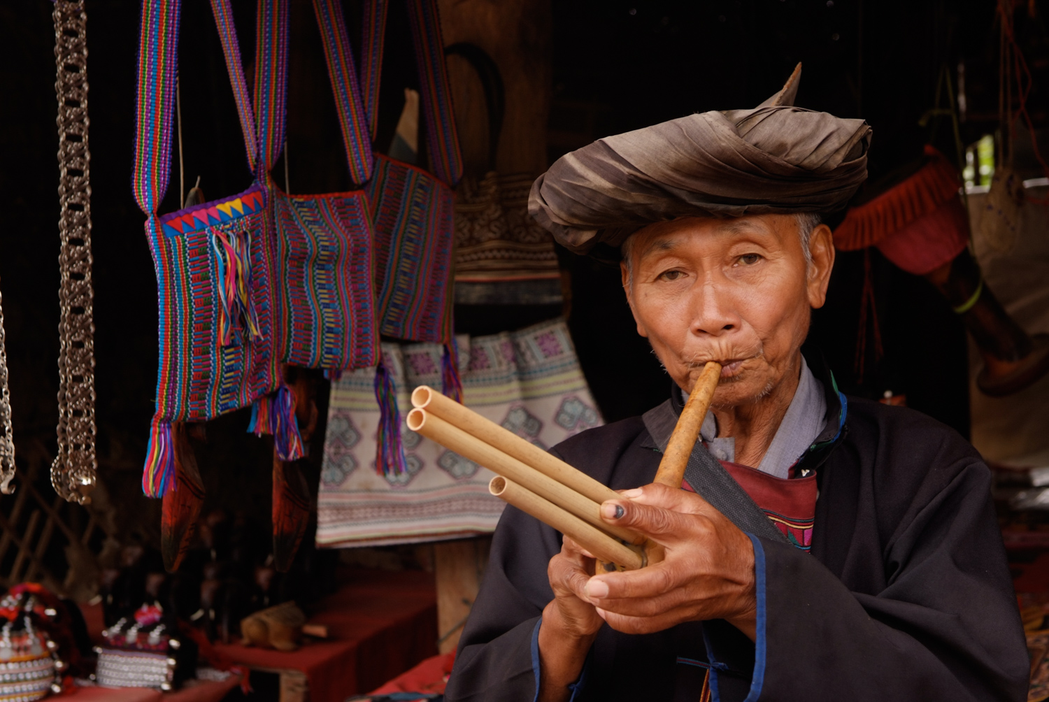 Hill tribesman playing bamboo flute in Laos
