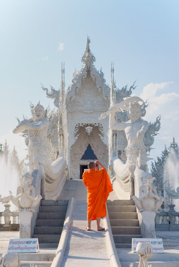 Monk photographing the White Temple in Chiang Rai, Thailand